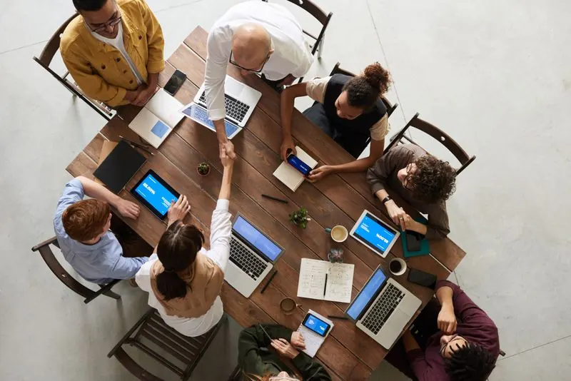 Trg HR recruitment team meeting with a client around a table