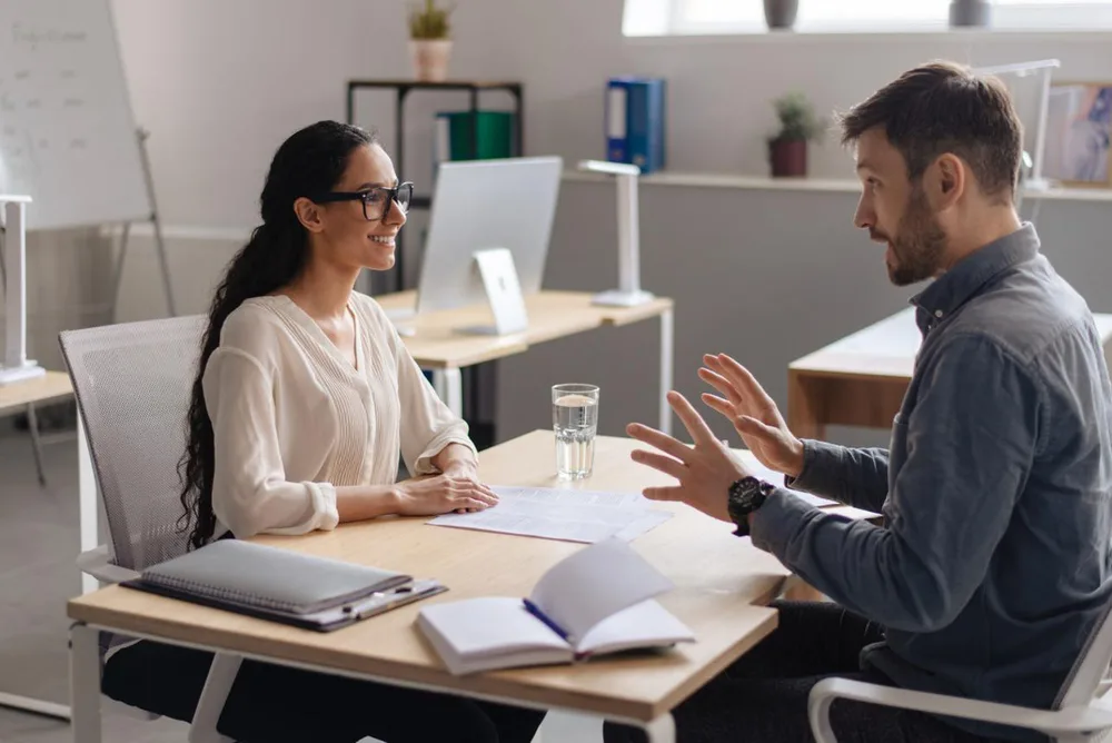 Professional consultant discussing temporary staffing requirements
