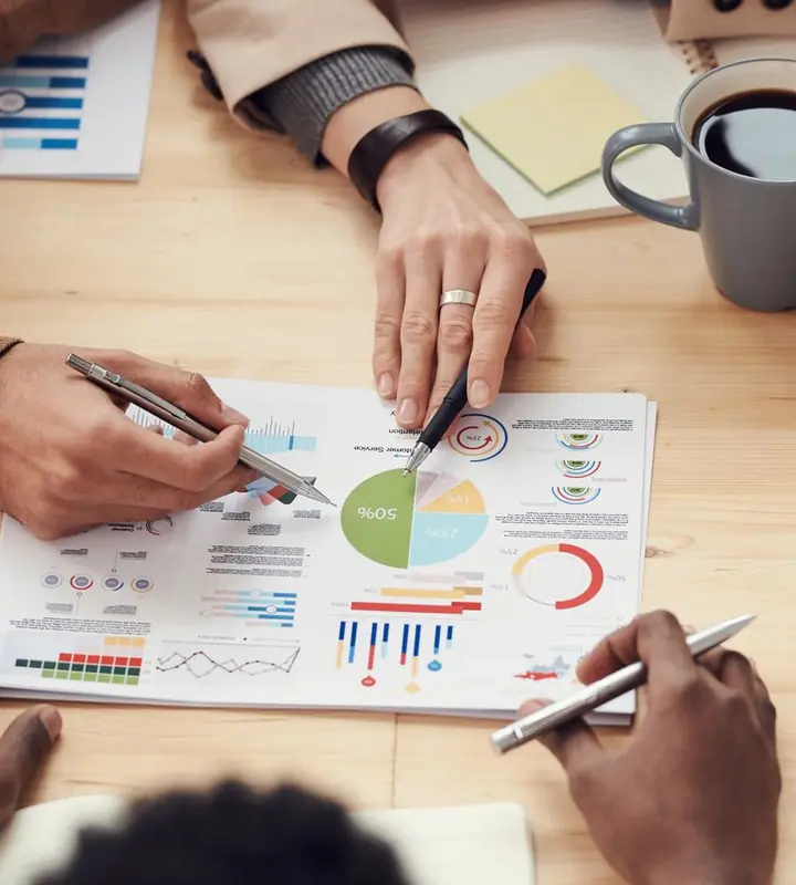 Reviewing recruitment cost and hiring budget charts at a meeting table
